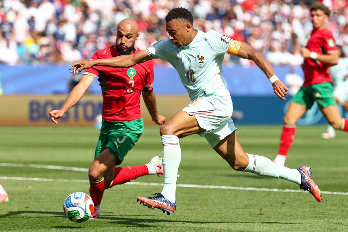 France's forward #10 Kylian Mbappe runs with the ball before being fouled by Morocco's defender #03 Noussair Mazraoui to concede a penalty during the 2026 World Cup football tournament quarter-final match between France and Morocco at Boston Stadium in Foxborough on July 9, 2026.