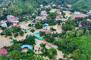 This aerial photograph shows partially submerged residential buildings following heavy rains in Bangladesh's Bandarban town on July 11, 2026.
