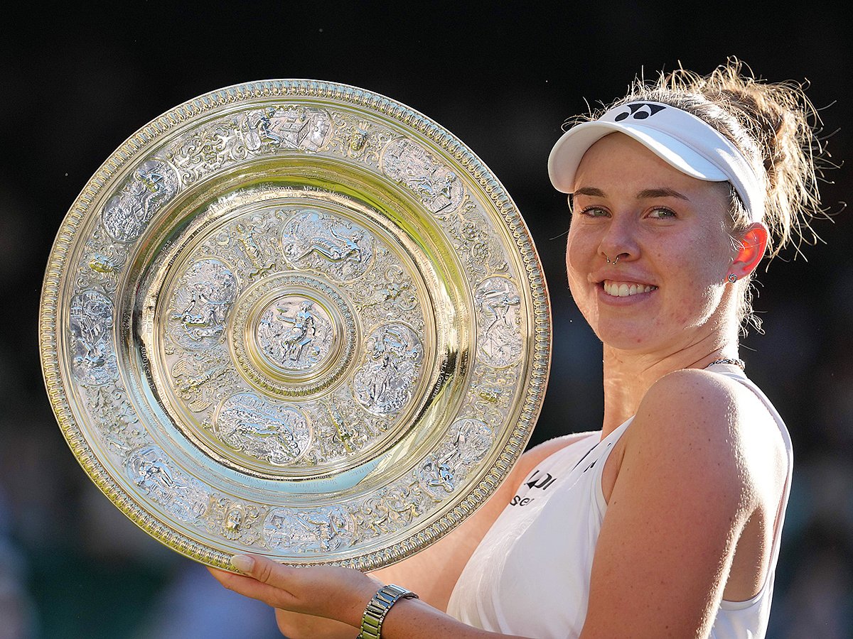 Linda Noskova of Czech Republic poses with the trophy after winning against Karolina Muchova of Czech Republic in the women's singles final at Wimbledon Tennis Championships in London, Saturday, July 11, 2026. 