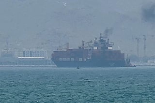 This frame grab taken from AFPTV video footage on July 12, 2026 shows a cargo ship anchoring near the Strait of Hormuz.