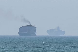This frame grab taken from AFPTV video footage on July 12, 2026 shows cargo ships anchoring near the Strait of Hormuz off the eastern coast of the United Arab Emirates at Khor Fakkan.