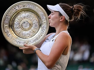 Czech Republic's Linda Noskova kisses the winner's trophy, the Venus Rosewater Dish, after beating Czech Republic's Karolina Muchova during their women's singles final of the 2026 Wimbledon Championships at The All England Lawn Tennis and Croquet Club in Wimbledon, southwest London, on July 11, 2026.