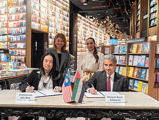 Sheikha Bodour witnesses the signing of the agreement by Ahmed bin Rakkad Al Ameri and Andrew Yap.