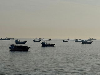 Vessels are seen anchored in the Strait of Hormuz, off the port city of Khasab on Oman’s northern Musandam Peninsula on May 17, 2026. 