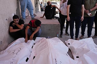 Palestinians mourn the bodies of people killed in an Israeli military strike on a residential building during their funeral at Al-Aqsa Hospital in Deir al-Balah, central Gaza Strip, Wednesday, July 15, 2026. 