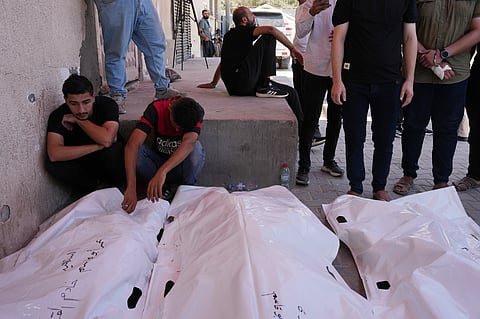 Palestinians mourn the bodies of people killed in an Israeli military strike on a residential building during their funeral at Al-Aqsa Hospital in Deir al-Balah, central Gaza Strip, Wednesday, July 15, 2026. 
