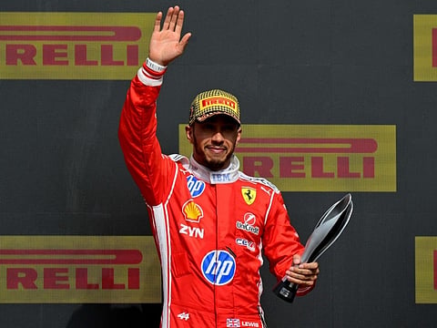 Lewis Hamilton waves from the podium following the Formula One British Grand Prix at the Silverstone motor racing circuit in Silverstone, central England, on July 5, 2026.