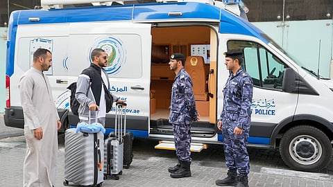 Ajman Police's mobile smart centre assists residents after tower fire.