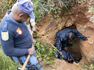 Officers of the South Africa Police Service (SAPS) recover a generator left behind by artisanal miners, during a patrol in Randfontein. [Illustrative image]