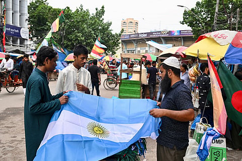 A street vendor sells Argentina's national flag in Dhaka on July 17, 2026, ahead of the 2026 FIFA World Cup final tournament.