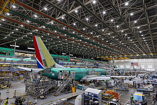 FILE - Boeing employees work on a 737 MAX airplane on the final assembly line at Boeing's plant in Renton, Wash., on June 15, 2022. 