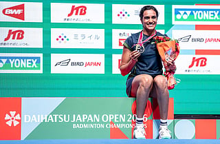 Gold medalist India’s Pusarla Venkata Sindhu poses on the podium after her victory against Japan’s Akane Yamaguchi in their women's singles final match of the Japan Open badminton tournament at Tokyo Gymnasium in Tokyo on July 19, 2026.