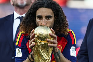 Spain's defender #24 Marc Cucurella kisses the trophy after winning the 2026 World Cup football tournament final match between Spain and Argentina at the New York/New Jersey Stadium in East Rutherford on July 19, 2026.