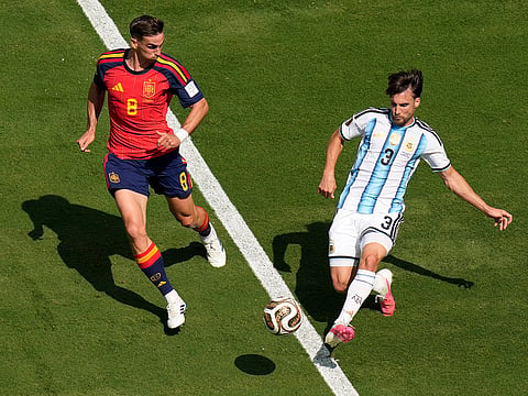 Argentina's Nicolas Tagliafico (3) passes the ball as Spain's Fabian Ruiz (8) looks on during the World Cup final in East Rutherford, N.J., near New York, Sunday, July 19, 2026. 