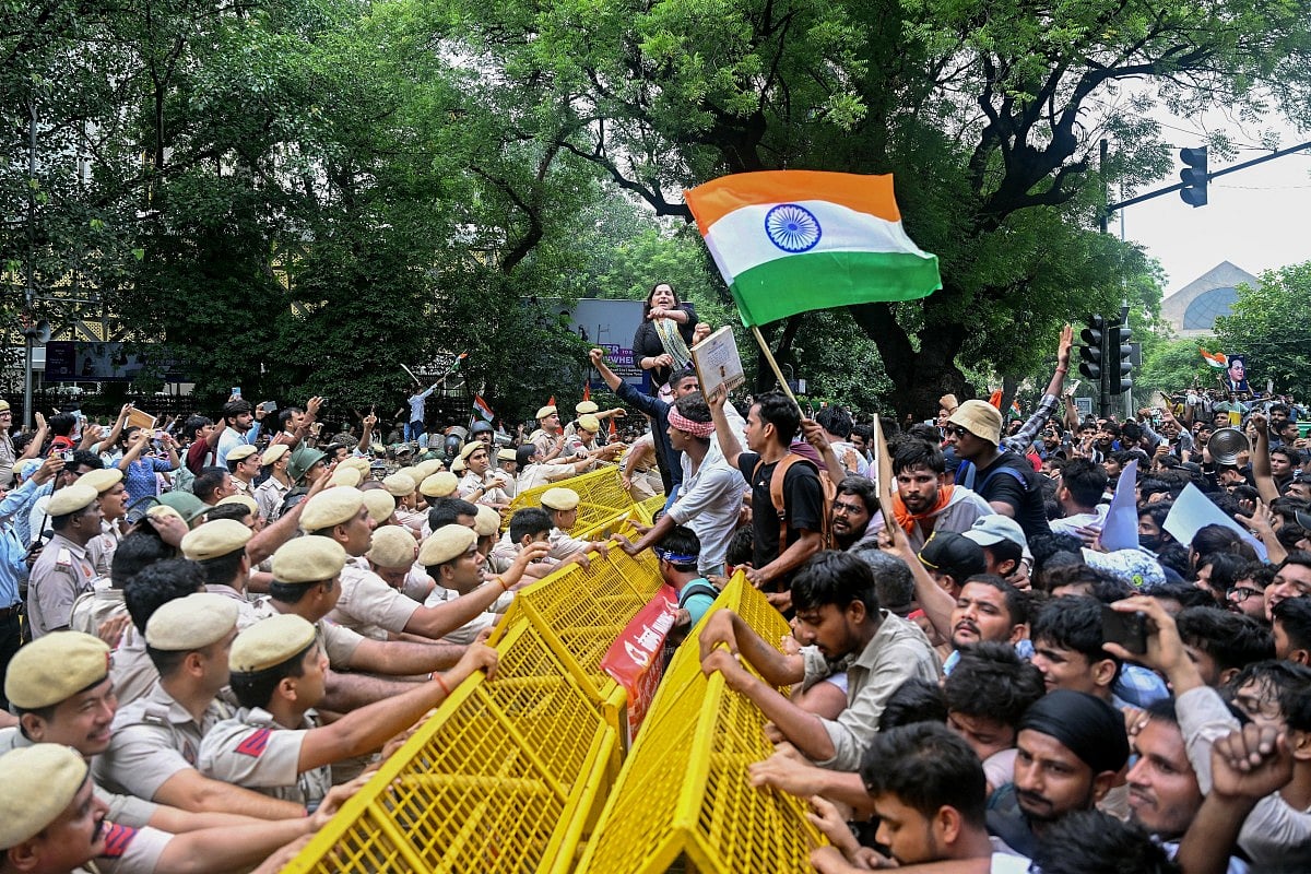 Activists and supporters of the Cockroach Janta Party (CJP) clash with police personnel during a protest demanding the resignation of India's Education Minister Dharmendra Pradhan over alleged NEET examination irregularities in New Delhi on July 20, 2026.