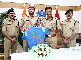 Indian fast bowler and DSP Mohammed Siraj (second left) meets Telangana Director General of Police (DGP) C.V. Anand (third from left) in Hyderabad.