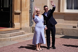 Labour Party leader Andy Burnham and his wife Marie-France van Heel, wave after an audience at Buckingham Palace, London, where Britain's King Charles III invited the leader of the Labour Party to become Prime Minister and form a new government, on July 20, 2026.