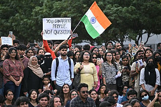 Cockroach Janta Party (CJP) supporters hold placards during a protest organised by the All India Students' Association (AISA) demanding the resignation of India's Education Minister Dharmendra Pradhan over alleged NEET exam irregularities at Freedom Park in Bengaluru on July 20, 2026.