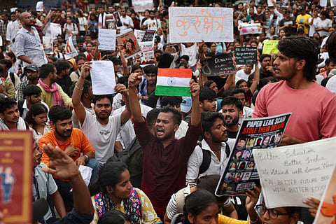 Banaras Hindu University (BHU) students in solidarity with Cockroach Janta Party (CJP) hold placards during a protest demanding the resignation of India's Education Minister Dharmendra Pradhan over alleged NEET exam irregularities in Varanasi on July 20, 2026.