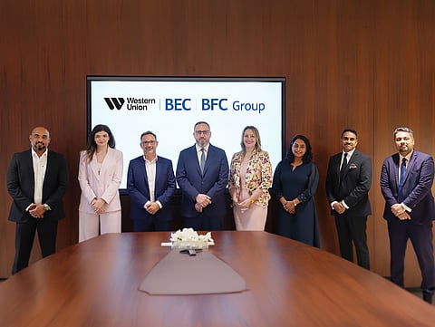 Mohammad Bitar, Deputy Group CEO of Al Ansari Financial Services, and Nicolas Levi, Regional Vice President and Head of the Middle East, Pakistan and Afghanistan at Western Union, with members of both teams at the signing ceremony.