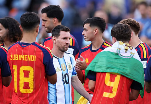 Lionel Messi #10 of Argentina walks to the podium while embraced by players of Spain at the ceremony following the FIFA World Cup 2026 Final match between Spain and Argentina at New York New Jersey Stadium on July 19, 2026 in East Rutherford, New Jersey.