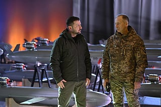 Ukrainian President Volodymyr Zelensky (L) and Commander-in-Chief of the Armed Forces of Ukraine Oleksandr Syrsky (R) speak next to the first batch of Ukrainian made drone missiles "Peklo" (Hell) delivered to the Defence Forces of Ukraine in Kyiv on amid the Russian invasion of Ukraine. Photo made available on December 6, 2024.