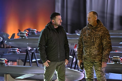 Ukrainian President Volodymyr Zelensky (L) and Commander-in-Chief of the Armed Forces of Ukraine Oleksandr Syrsky (R) speak next to the first batch of Ukrainian made drone missiles "Peklo" (Hell) delivered to the Defence Forces of Ukraine in Kyiv on amid the Russian invasion of Ukraine. Photo made available on December 6, 2024.