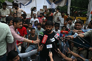 Cockroach Janta Party (CJP) founder Abhijeet Dipke speaks to the media during a protest demanding the resignation of India's Education Minister Dharmendra Pradhan over alleged NEET exam irregularities, in New Delhi on July 21, 2026.