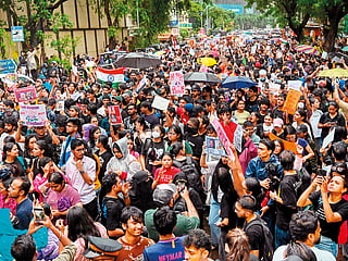 
Demonstrators hold placards during a protest gathering in Mumbai on July 22, 2026 in solidarity with the ongoing protest at New Delhi's Jantar Mantar demanding the resignation of India's Education Minister Dharmendra Pradhan over alleged NEET exam irregularities.   