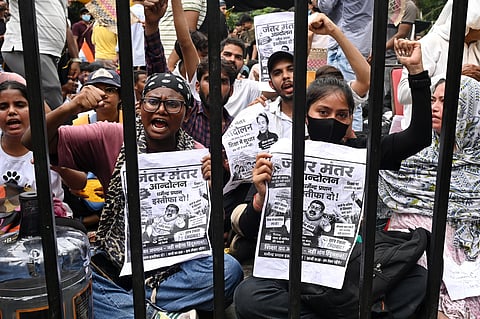 Protesters shout slogans as they carry posters asking for the resignation of India's Minister of Education Dharmendra Pradhan at a protest led by Cockroach Janta Party in New Delhi, India, Wednesday, July 22, 2026. (AP Photo/Vipin)
