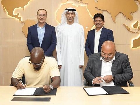 Muhammad Khalid (F-L), AIREV founder, and Sayantan Dev (F-R), President of MEA at Redington, sign the agreement, in the presence of Dr Thani Al Zeyoudi (B-C), UAE Minister of Foreign Trade and Chairman of AIREV.