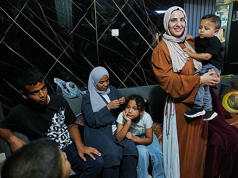 Mais Al Gharam holds her son as she stands with her siblings from Gaza, who were granted Israeli passports, in her home in Nazareth, Israel, Wednesday, July 8, 2026. 