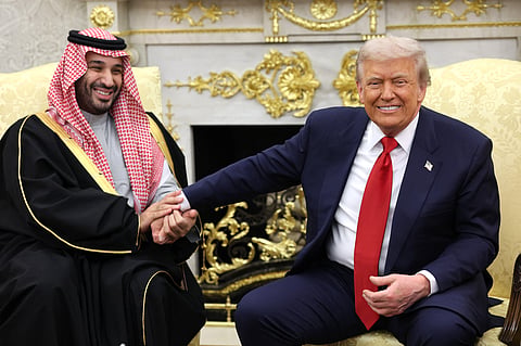 U.S. President Donald Trump (R) takes the hand of Crown Prince and Prime Minister Mohammed bin Salman of Saudi Arabia during a bilateral meeting in the Oval Office of the White House on November 18, 2025 in Washington, DC. 