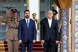 A handout picture provided by the Iranian Presidential Office shows on July 23 2026, Iranian President Masoud Pezeshkian (R) and Iraqi Prime Minister Ali al-Zaidi during a welcome ceremony in the Iranian capital Tehran.