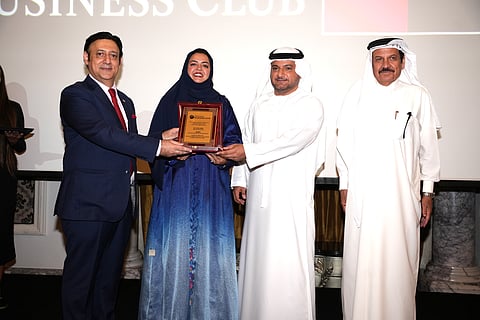 Sarah Shah receiving a shield from Javed Malik (left) Dr Omar Al Muthanna from CDA and Dr Youssef Issa Hassan AL Sabri, former UAE Ambassador.