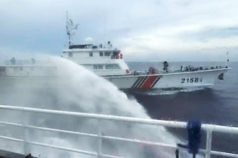 This handout screengrab taken on July 24, 2026 and released by the Philippine Coast Guard (PCG) shows a Chinese Coast Guard ship (back) firing water canon on a Philippine Bureau of Fisheries and Aquatic Resources (BFAR) ship near Scarborough Shoal, in the disputed South China Sea.