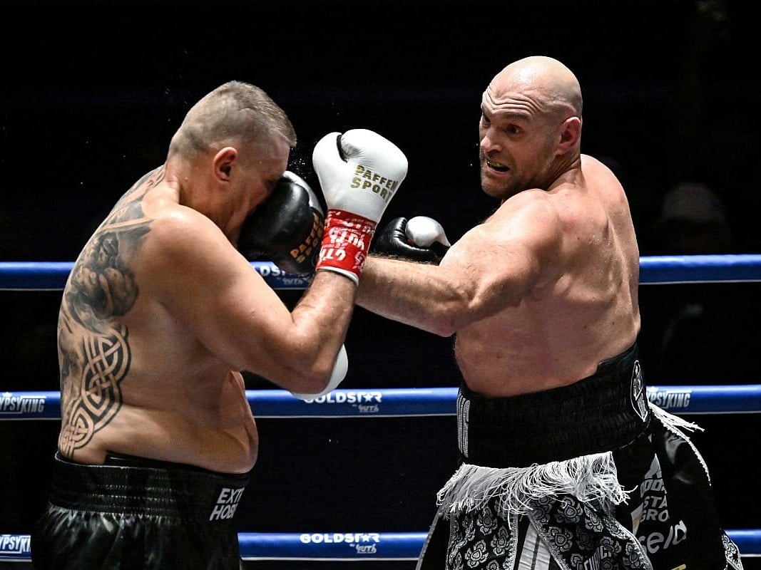 Britain's Tyson Fury (R) trades blows with Poland's Mariusz Wach (L) during a charity boxing bout in Pattaya on July 24, 2026.