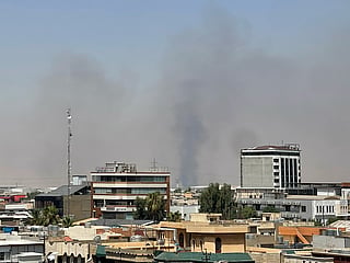 Black smoke rises following explosions near a military base hosting US forces in the northern Iraqi city of Irbil, on Friday, July 24, 2026.