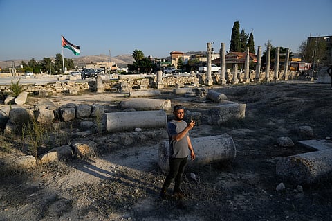FILE - A Palestinian visitor takes a photo at the Roman historical site in the West Bank town of Sebastia Thursday, Nov. 20, 2025. (AP Photo/Nasser Nasser, File)