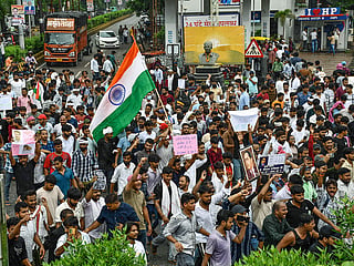 Students stage a protest in support of the Cockroach Janata Party (CJP), demanding the resignation of Union Education Minister Dharmendra Pradhan over alleged examination irregularities and NEET paper leak, in Prayagraj on Saturday. 