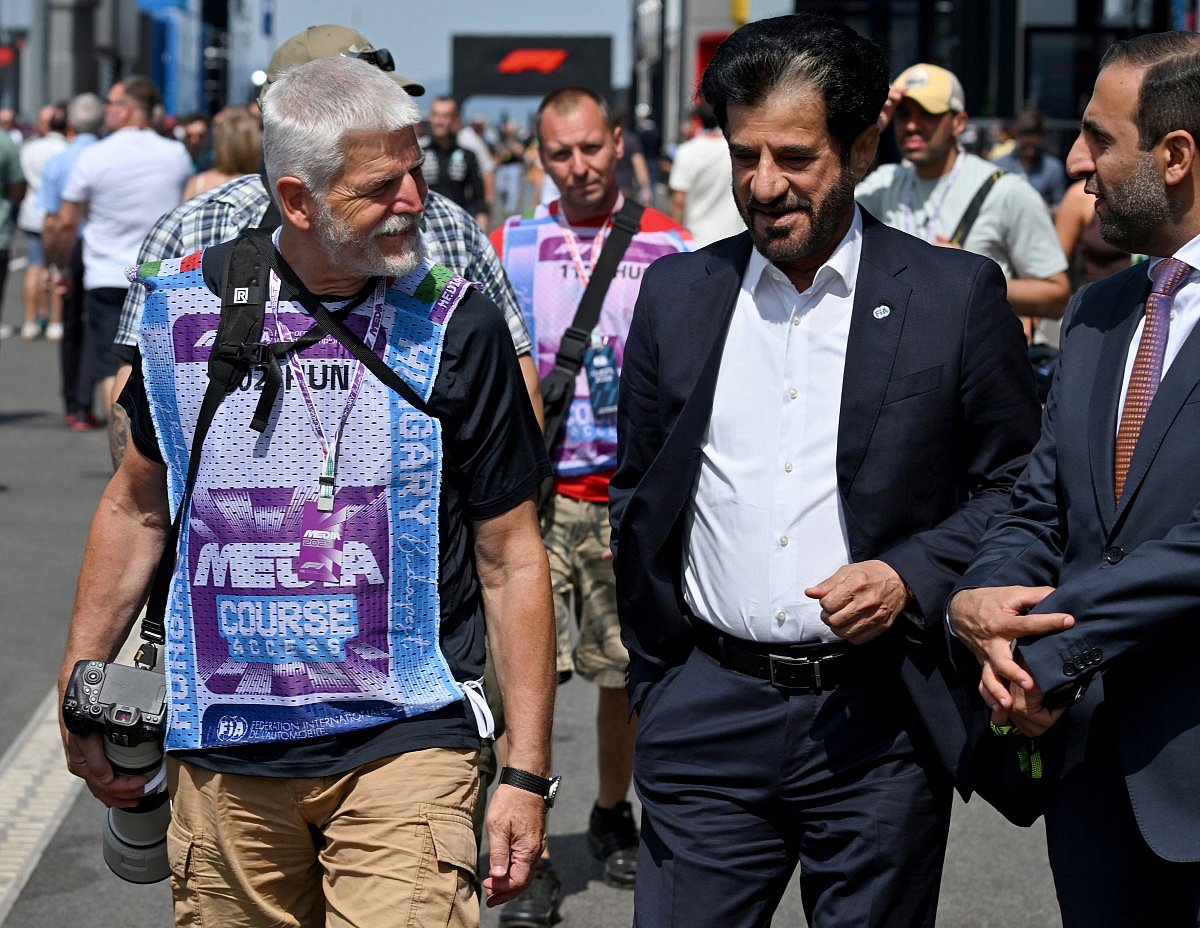 Czech Republic's President Petr Pavel (L) walks in the paddock with FIA President Mohammed Ben Sulayem (C) ahead of the Formula One Hungarian Grand Prix at the Hungaroring racetrack in Mogyorod near Budapest, Hungary, on July 26, 2026.