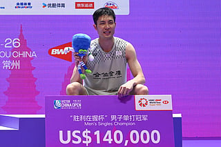 Taiwan's Chou Tien-chen poses on the podium after defeating France's Toma Junior Popov after the men's singles final match at China Open badminton tournament in Changzhou, eastern China's Jiangsu province on July 26, 2026.
