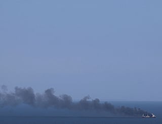 Smoke rises from a civilian ship in the Black Sea off Odesa. Attacks on commercial vessels in the region have increased since April 2026.