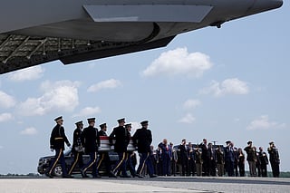 President Donald Trump and Secretary of Defense Pete Hegseth and others, salute as a U.S. Army carry team moves a transfer case containing the remains of Sgt. Angel S. Rampersad, of Ozone Park, N.Y. Wednesday, July 22, 2026, at Dover Air Force Base, Del. (AP Photo/Matt Rourke)