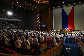 House members stand as Philippines President Ferdinand Marcos Jr (R) arrives to deliver his speech during the State of the Nation Address (SONA) at the House of Representatives in Quezon City, Metro Manila on July 27, 2026.