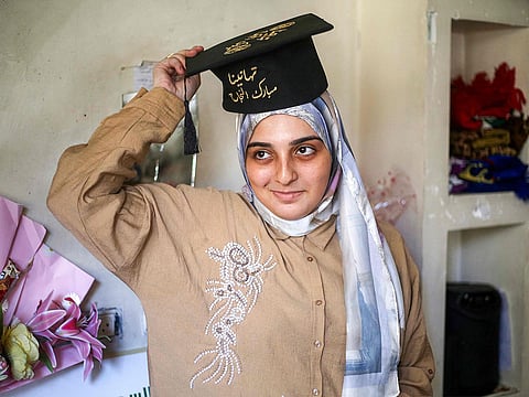 Palestinian high school student Saba Rabah, the top-ranked student in the science stream of the Palestinian national high school exams, celebrates at the Maghazi camp for Palestinian refugees in the central Gaza Strip on July 26, 2026.  