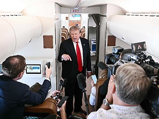 US President Donald Trump speaks to the press on board Air Force One, in the air en route to Michigan, on July 27, 2026. 