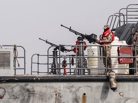 Sailors from the navy of Yemen's Aden-based internationally recognised government stand at machine-gun positions aboard a vessel patrolling a shipping lane off Hanish Island in the Red Sea.