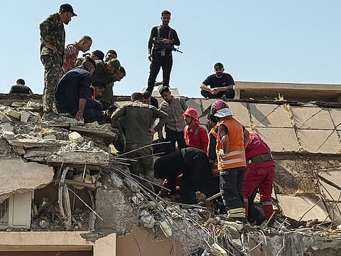 Security forces and emergency personnel work at the site of a strike north of Al Miqdadiyah district in Iraq's Dayala province. 