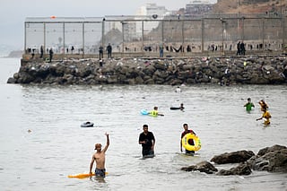 Migrants swim through the waters close to the border with Morocco to enter Spain's north Africa's Ceuta enclave.